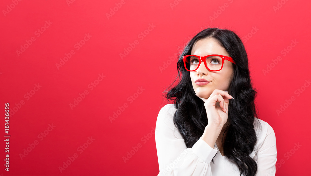 Young businesswoman in a thoughtful pose on a solid background Young businesswoman in a thoughtful pose on a solid background