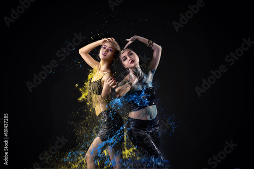 Portrait of two asian belly dancer perform with colorful paint