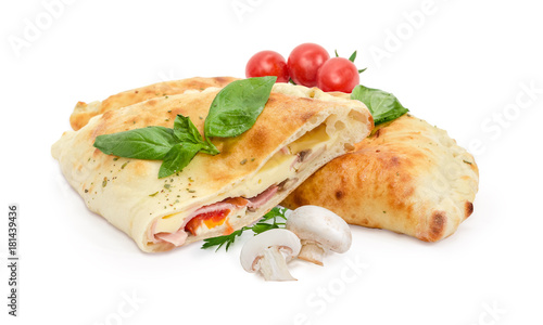 Foto Whole and half of baked calzone, mushrooms, cherry tomatoes