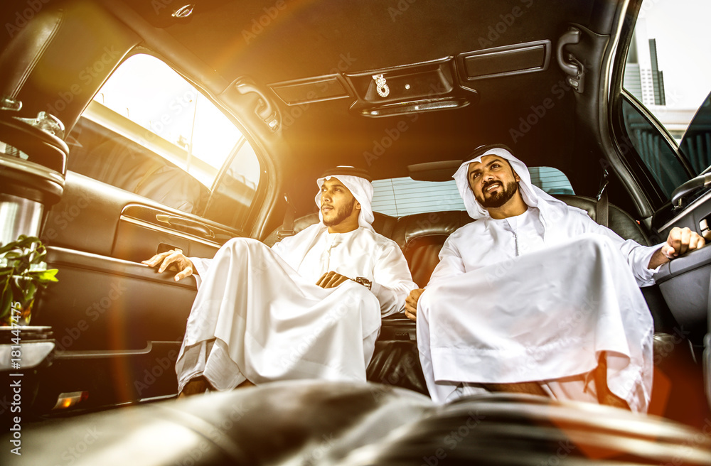 Fototapeta premium Two arabian businessmen talking about business in the company limousine
