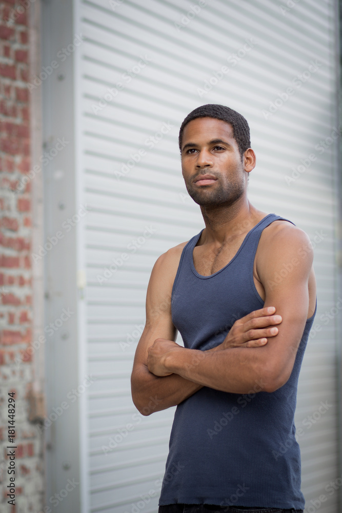 Young handsome African American man with arm crossed in the rough neighborhood Young handsome African American man with arm crossed in the rough neighborhood