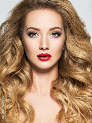 Pretty woman with long hair and red lips.