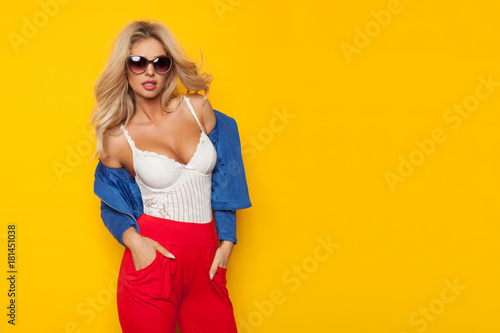 Sexy Blond Woman In Sunglasses, White Corset And Blue Unbuttoned Jacket