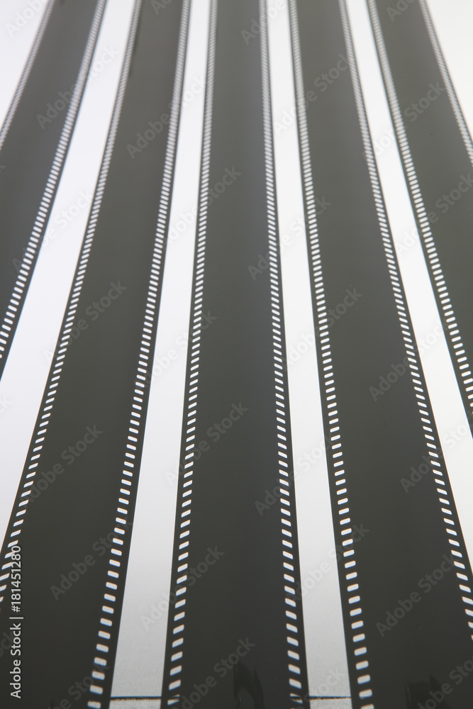 Fototapeta premium The unrolled exposed 35mm film strips over a white background