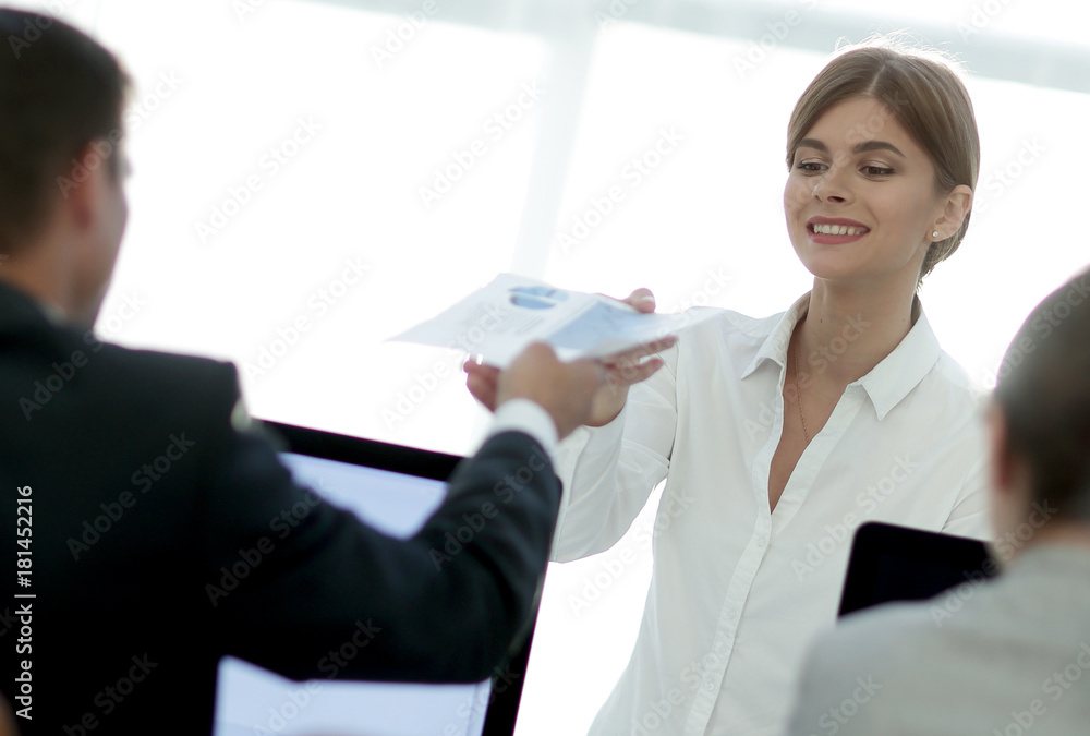 senior Manager, handing the employee a document with financial data. senior Manager, handing the employee a document with financial data.