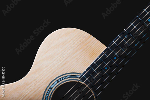 acoustic guitar & beautiful rim light of six strings, frets and body shape, isolated on black for music background
