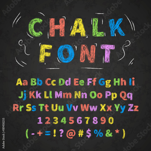 Colorful retro hand drawn alphabet letters drawing with chalk on black chalkboard