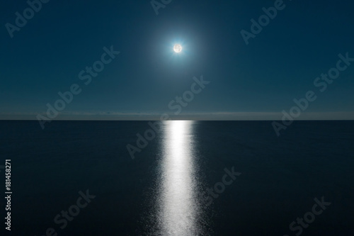 Seascape with the full moon over the sea and the moon glade 