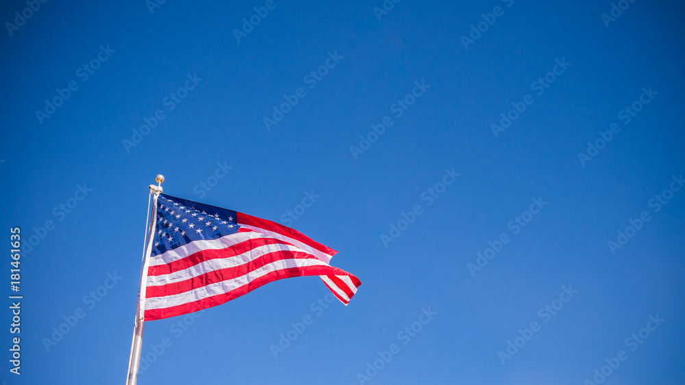 USA American Flag waving with clear blue sky background in Horizontal view