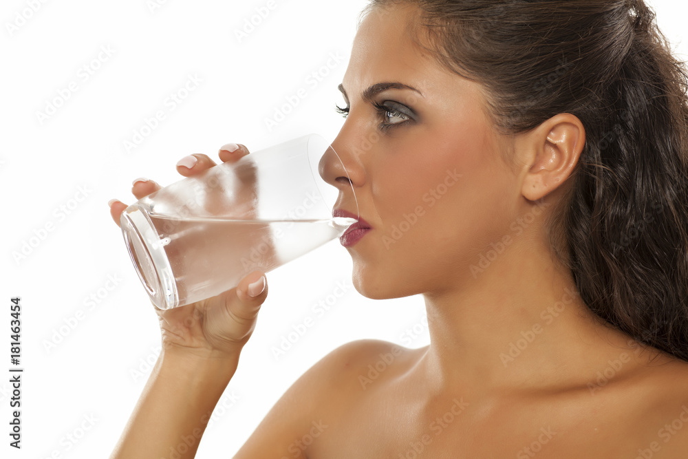 a young woman drinks cold water from the glass a young woman drinks cold water from the glass
