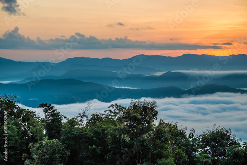 Beautiful Sea of mist in the morning with layer of mountain and sunrise in HDR view concept