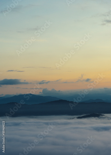 Beautiful Sea of mist in the morning with layer of mountain and sunrise