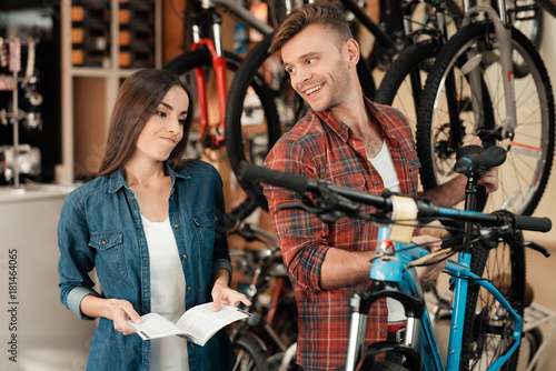 A young couple came to the bicycle shop to choose a new bicycle.