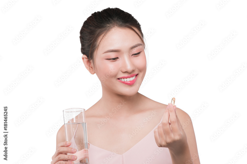 Smiling asian woman eating pills and drinking water Smiling asian woman eating pills and drinking water