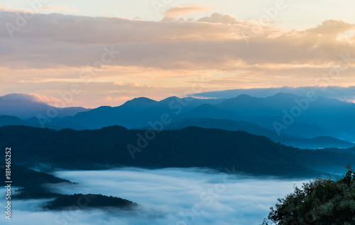Beautiful Sea of mist in the morning with layer of mountain and sunrise scene