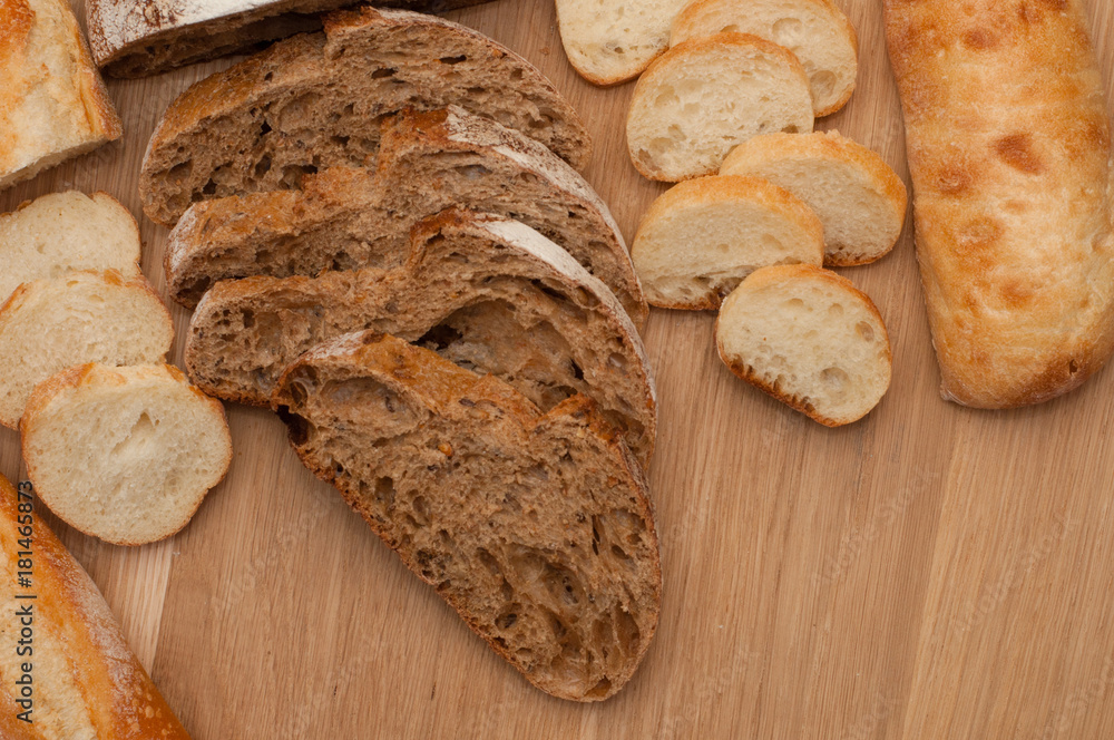 Naklejka premium Bread chopped on wooden board with space for text