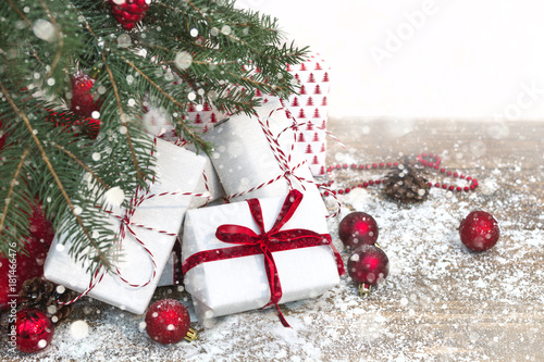 Christmas holiday background. Gifts under christmas tree. Copy space. Effect drawn snow.