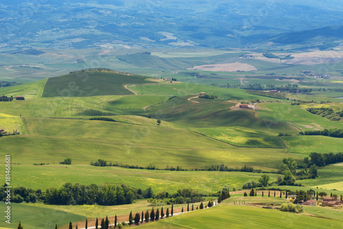 Magnificent spring landscape.Beautiful view of typical tuscan farm house  green wave hills  cypresses trees  hay bales  olive trees  beautiful golden fields and meadows.Tuscany  Italy  Europe