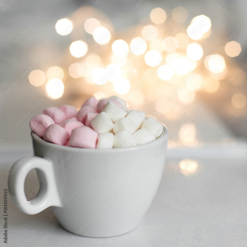 Cup of hot chocolate and marshmallow in the background of Christmas decorations. Cup of hot chocolate and marshmallow in the background of Christmas decorations.