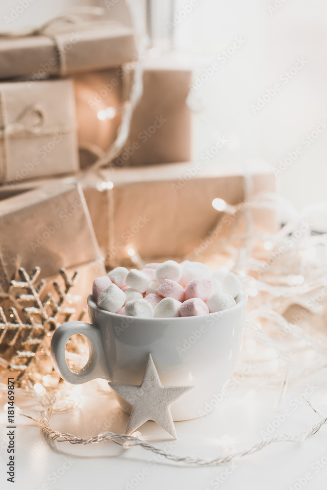 Cup of hot chocolate and marshmallow in the background of Christmas decorations. Cup of hot chocolate and marshmallow in the background of Christmas decorations.