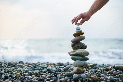 Canvas Print Pyramid of stones on the beach. Stone tower