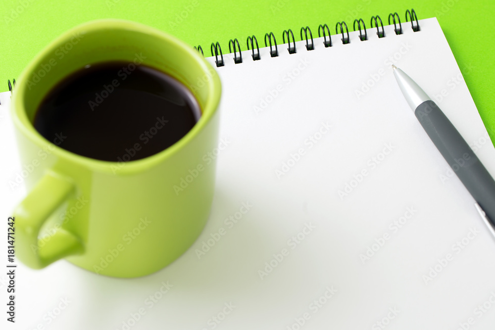 Blank notepad with a cup of coffee and pen Blank notepad with a cup of coffee and pen