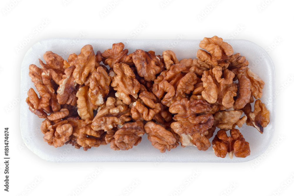 Walnut kernel halfs in a container on white background