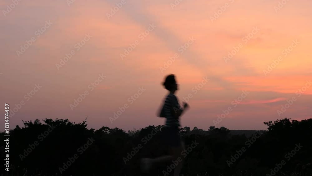 woman runBlurry silhouette Young Asia woman running at running  in countryside with sky twilight background . Video