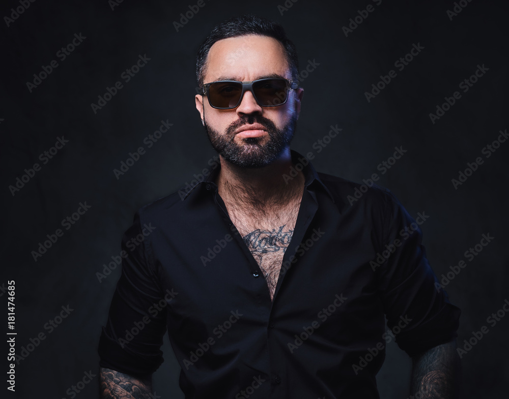 A man with tattoos on arms and neck. A man with tattoos on arms and neck.