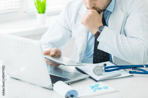 The doctor prescribes a prescription medication sitting in his office