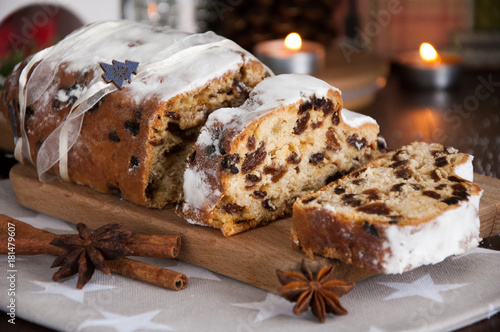 Sliced Christmas Stollen. Traditional german christmas cake with dried fruits and icing sugar