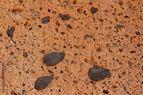 Natural orange rock texture background with black lapillus inclusions, Tenerife photo