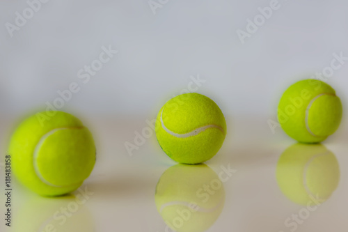 Close up of tennis balls on white background. Shallow depth of focus. Concept sports. © Ganka