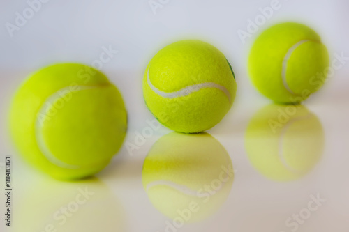 Close up of tennis balls on white background. Shallow depth of focus. Concept sports. © Ganka