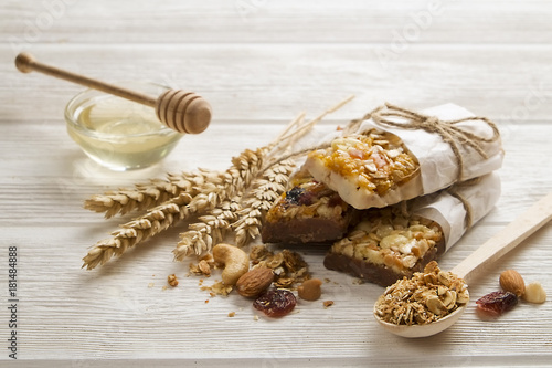 Homemade gluten free granola bars on wooden background. 