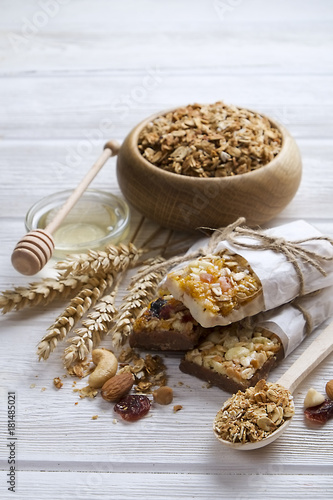 Homemade gluten free granola bars on wooden background. © Evrymmnt