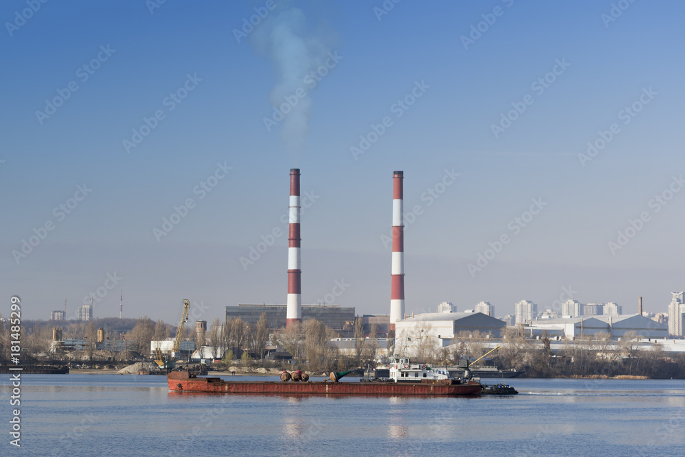 Two striped pipes smoke against a blue sky horizontal Two striped pipes smoke against a blue sky horizontal