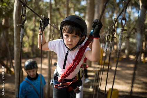 Determined boy crossing zip line