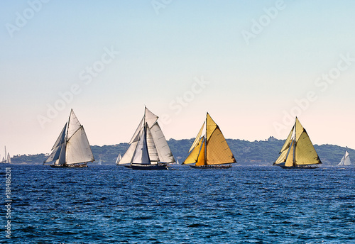 Four old sailboats on sea