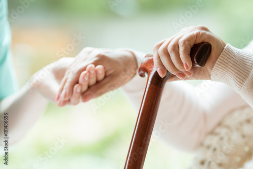 Elder person supported on stick photo