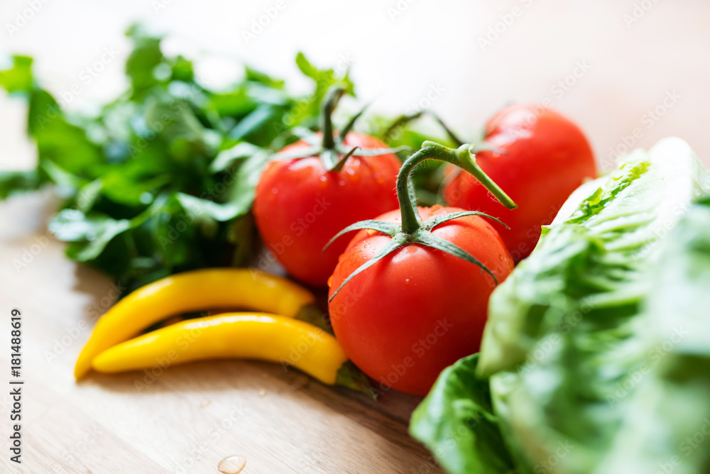 fresh ingredients for green salad on wooden kitchen table