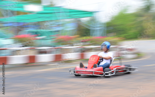 Young man driving to the kart with speed. © bigjom