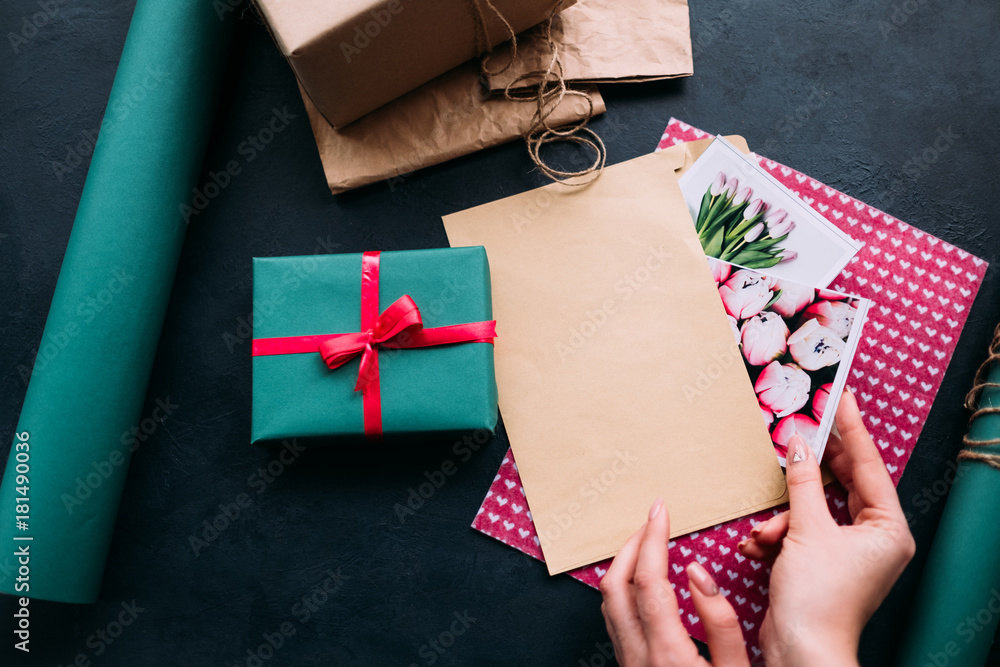 Fototapeta premium professional holiday preparation on dark background. cute postcards for women. present for birthday, mothers day, womens day, and other occasions.