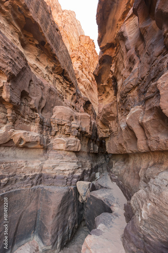 A narrow pass between to gigantic sandstone mountains in the Wadi Rum, Jordan.