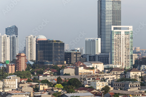 Low rise residential district and towers in Jakarta, Indonesia capital city.