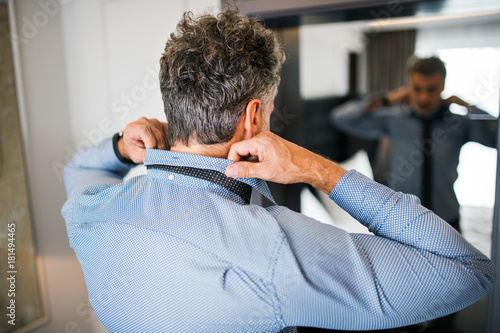 Mature businessman in a hotel room. photo