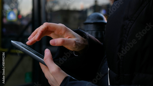 Close up on the hand of young woman using tablet - technology, social network, communication concept