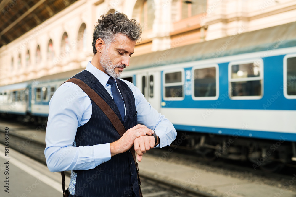 Mature businessman on a train station. Mature businessman on a train station.