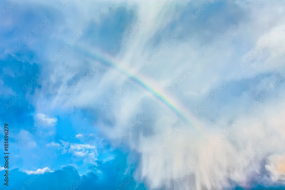 Natural rainbow over blue sky and white clouds Natural rainbow over blue sky and white clouds