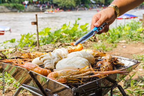 Shrimp and squid grill on a hot stove look so delicious which is a simple menu for cooking during camping